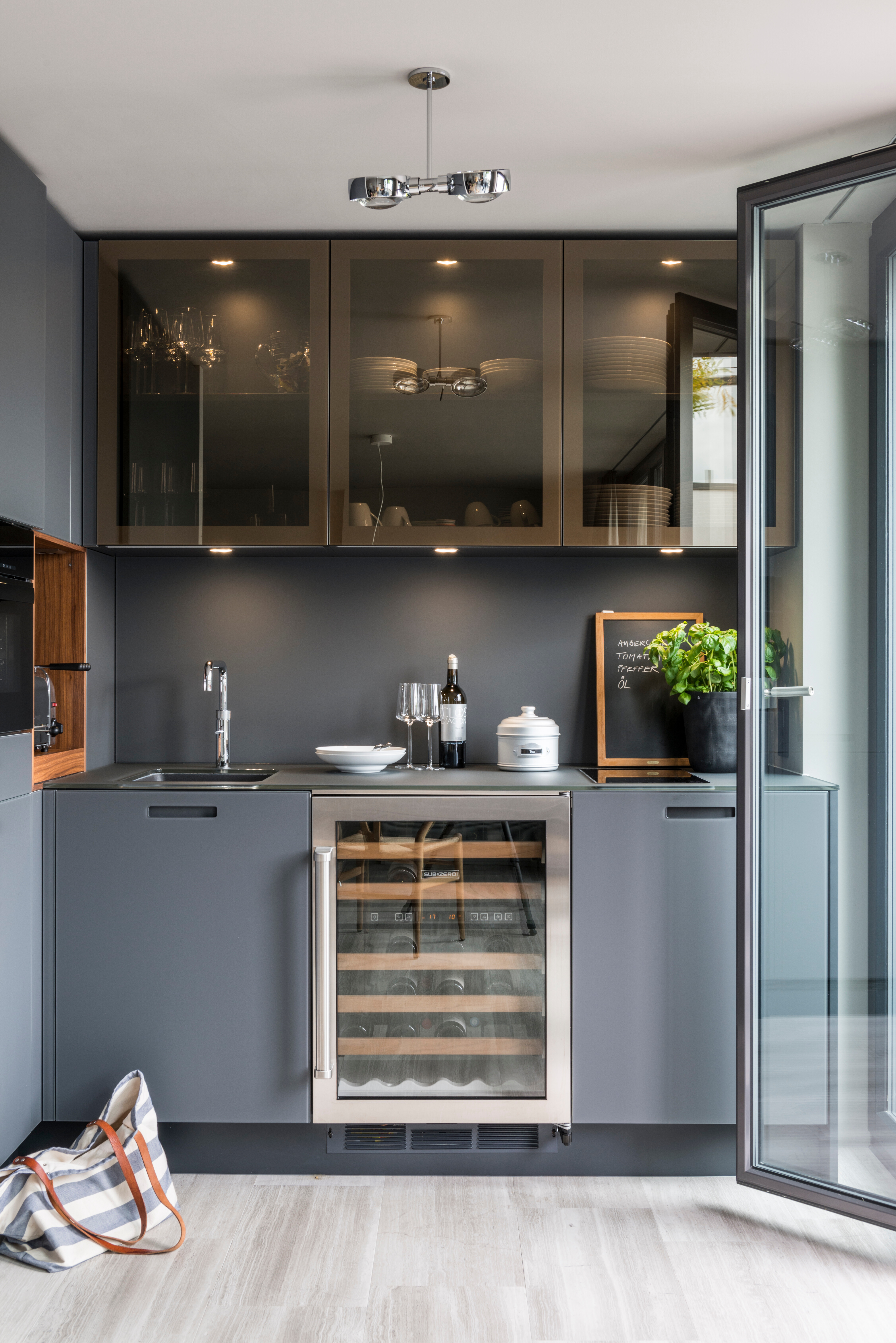 Küche Kyton Glas von Varenna, Stuhl Y-Chair von Hans J. Wegner. Exklusiver Weinlagerschrank von Coolgiants, Dampfgarer von Miele