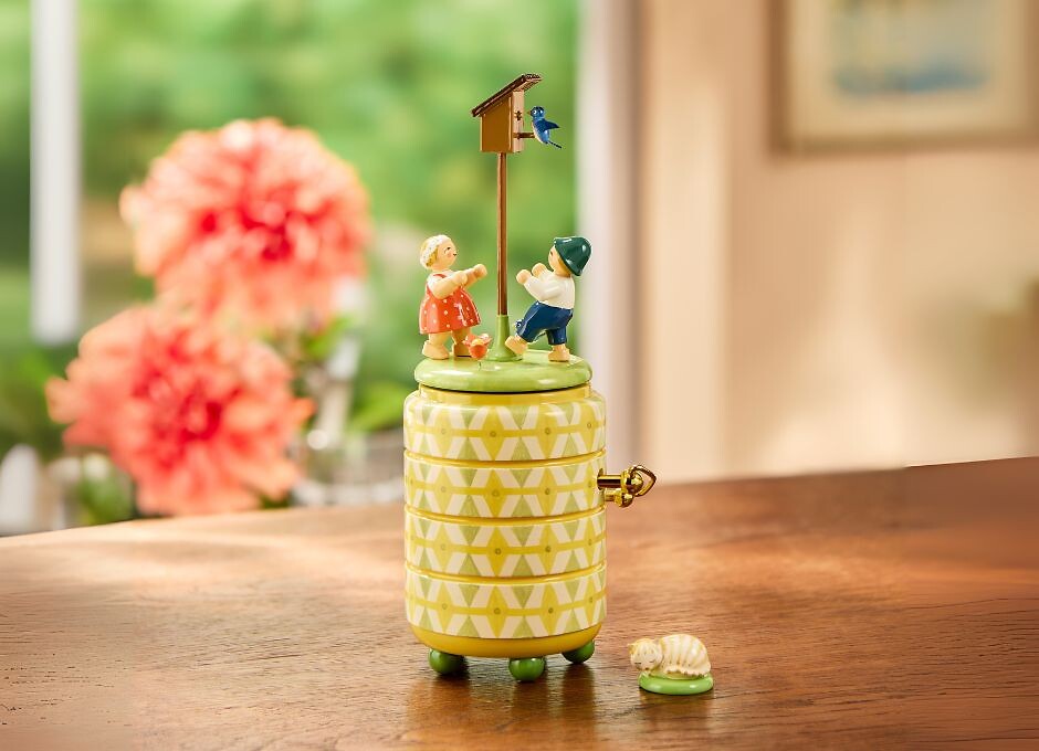 zwei Blumenkinder auf Spieldose mit Nistkasten