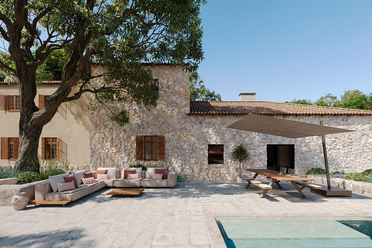 Eine weitläufige Steinterrasse präsentiert die vielseitige Outdoor-Möblierung von Extremis. Das komfortable Walrus Sofa und die funktionale Panigiri Bank-Tisch-Kombination, beschattet vom Sensu Sonnenschirm, bieten ideale Bereiche zum Entspannen und Genie